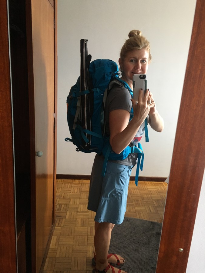 Final adjustments to my Camino backpack with umbrella strapped to side of backpack.