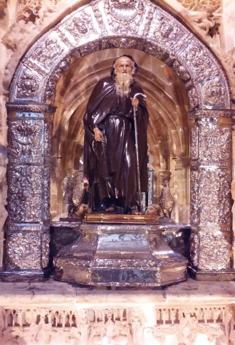 St. Dominic is depicted with a rooster and hen