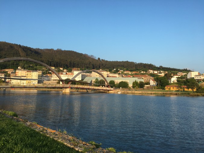 View of the footbridge with the orange municipal albergue on the right and Pension Maragoto on the left.