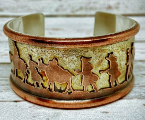 Sterling silver and copper cuff bracelet depicting the Alto del Perdón Sculpture scene.